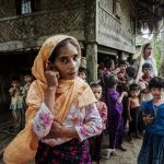 A Rohingya family stands outside their home in Maung Hnama village, Buthidaung township, western Myanmar's Rakhine state, July 13, 2017. Courtesy to Benar News