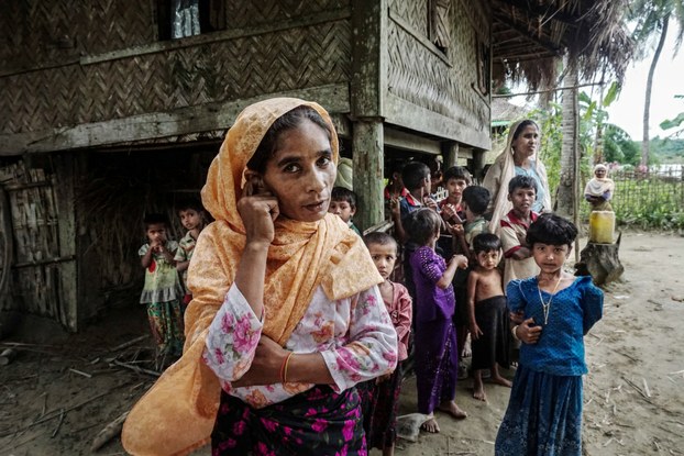 A Rohingya family stands outside their home in Maung Hnama village, Buthidaung township, western Myanmar's Rakhine state, July 13, 2017. Courtesy to Benar News